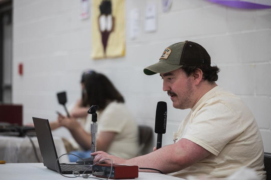 Trey Porter speaks into a microphone from Fuhrer Fieldhouse. He livestreamed coverage of the Doane/Saline County Relay for Life event on April 14 for 91.1 KDNE.